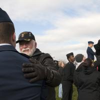 Volunteers thank and speak to each other after hanging wreaths up for Wreaths Across America