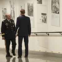 18th Chairman of the Joint Chiefs of Staff Army Gen. Martin E. Dempsey views the newly unveiled photo exhibit “National Memories” at the Pentagon