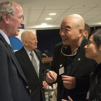 Zhang Dongpan (right) speaks with a DoD fan about  an exhibit highlighting US-China military alliance during WWII