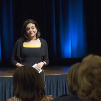 Sheryl Sandberg speaking to group of people about her book Lean In: Women, Work, and the Will to Lead