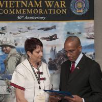 MG Arnold Fields presents a certificate on behalf of the United States of American Vietnam War Commemoration at the National League of Families 46th Annual Meeting