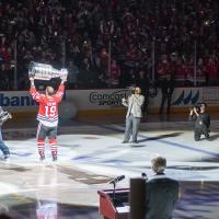 Jonathan Toews holds high Stanley Cup for banner raising ceremony