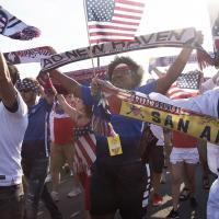 A group of American Outlaws parading into a USMNT game