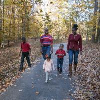 Family walking along path posing for a picture