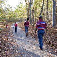 Family walking along path posing for a picture