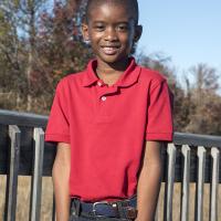 Young boy posing for a picture with hands in pocket