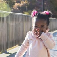 Young girl running and posing for a picture