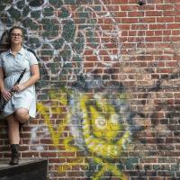 Young female posing for senior picture on location with clarinet in hand