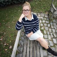 Young female posing for senior picture on location on a bench