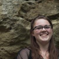 Young female posing for senior picture on location smiling