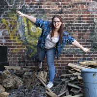 Young female posing for senior picture on location on one foot