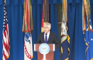 Chuck Hagel speaking on a podium at the Pentagon